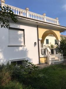 a white house with an arch and a window at Stefano's House in Rimini