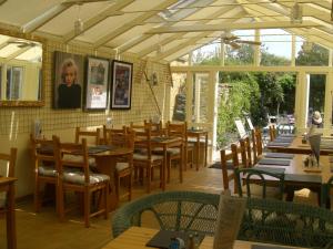 a restaurant with wooden tables and chairs in a room at Montacute Country Tearoooms in Montacute +5 photos