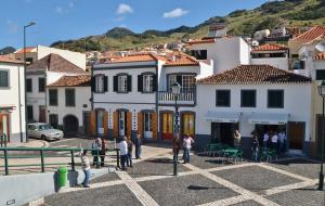 a group of people standing in a parking lot in a town at Sweet Home for Holidays in Machico