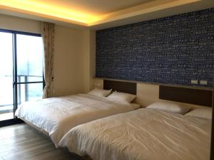 Postel nebo postele na pokoji v ubytování So Lohas B&B