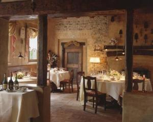 a dining room with tables and chairs in a building at Hotel L'Ultimo Mulino in Bannia