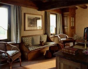 sala de estar con sofá y 2 ventanas en Hotel L'Ultimo Mulino, en Bannia