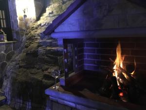 a fireplace with a glass of wine next to it at Villa Aurelia Old Town in Kavala