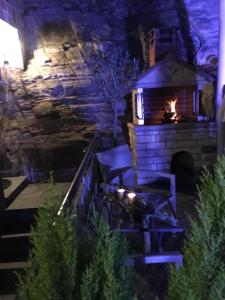 a stone fireplace with chairs in front of a brick wall at Villa Aurelia Old Town in Kavala