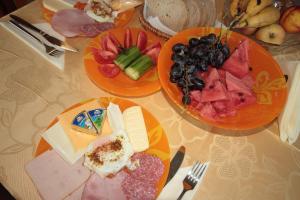 dos platos de comida en una mesa con fruta en Yan BibiYan Guest House en Negushevo