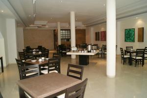 a dining room with tables and chairs in a restaurant at Savoy Express in Torreón