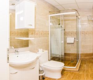 a bathroom with a shower and a toilet and a sink at Centric Lifestyle Apartments in Budapest +17 photos