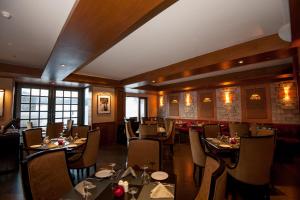 a restaurant with tables and chairs in a room at The Vintage Gulmarg in Gulmarg
