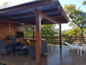 a wooden deck with a bar and a grill at Residencial Pousada do Serrano in Gramado