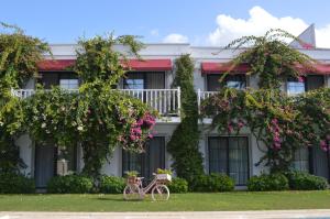 فندق فيلا روستيكا  في غوندوغان: دراجة متوقفة أمام مبنى به زهور