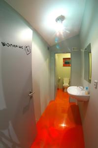 a bathroom with a white sink and a toilet at Penzion UAX in Trojanovice