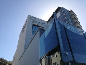 a blue building with a blue roof and a blue sky at Sugar Hotel in Cape Town
