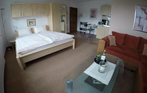 a bedroom with a bed and a couch and a table at Ferienwohnungen Albers in Winterberg