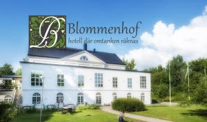 a large building with a clock on the front of it at Blommenhof Hotel in Nyköping