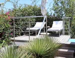 two chairs sitting on a deck next to a pool at DysArt Boutique Hotel in Cape Town