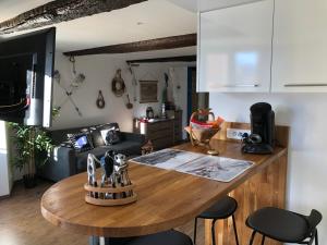a kitchen and living room with a wooden table at le petit bateau in Menton
