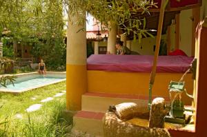 a man laying in a bed next to a swimming pool at Termas Aqua Libera in Aljucén