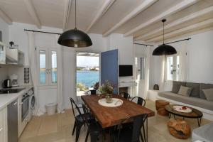 a kitchen and living room with a table and chairs at Kalypso Villas in Naousa