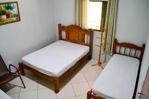 En eller flere senge i et værelse på Recanto Vovô Octávio - Refúgio Encantador em meio a Natureza + 37 billeder