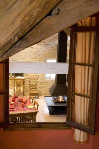 een woonkamer met een tafel en een open haard bij Gite Le Meix Chapeau in Levernois