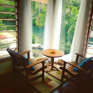 a room with a table and chairs and a window at Salt Lake Lodge in Savusavu