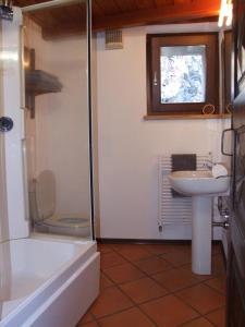 a bathroom with a toilet and a sink and a tub at Le Rocher in Châtillon +29 photos
