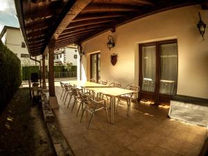 a wooden table and chairs on a patio at GURE-LUR casa rural in Sumbilla