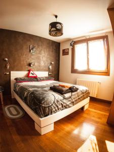a bedroom with a bed and a window at GURE-LUR casa rural in Sumbilla