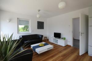 a living room with a couch and a coffee table at Ferienhaus Caputh in Caputh