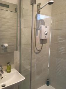 a bathroom with a shower and a sink at Thornsgill House Bed & Breakfast in Askrigg
