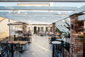 an outdoor patio with tables and chairs and a building at Sundial Boutique Hotel in Zagreb