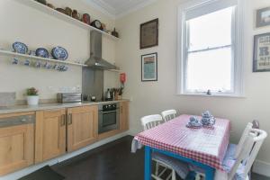 a kitchen with a table with a red and white table cloth at The Merchants House in Kilrush