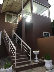 a house with stairs in front of it at Hotel Guaporé - Campo Bom RS in Campo Bom +22 photos