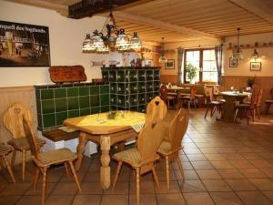 a dining room with a table and chairs in a restaurant at Landhotel Alt-Jocketa in Pöhl
