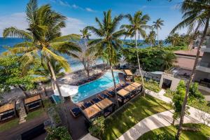 an aerial view of a resort with a pool and palm trees at Katamaran Hotel & Resort in Senggigi