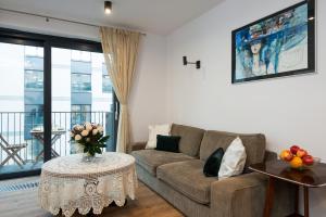 a living room with a couch and a table at Old Town, Kazimierz, large luxurious, 2 bedroom 2 bathroom, Airco in Krakow