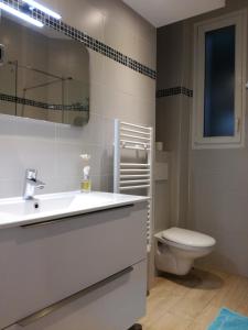 a bathroom with a sink and a toilet at Nice Promenade Apartment in Nice