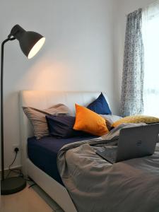 a bedroom with a bed with a laptop on it at 1-2 Guests, HBO-GO TV, Located High Level, Quiet-Studio Home, Cybersquare in Cyberjaya, Flexihome-MY in Cyberjaya
