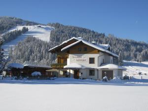 ein Gebäude im Schnee auf einem schneebedeckten Berg in der Unterkunft Ferienhaus Fallenegger in Flachau