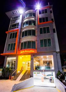 a building with a staircase in front of it at night at 24@Home Hotel in Nonthaburi