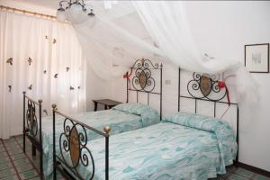 a bedroom with a bed with a canopy at Villa degli Scoiattoli in SantʼElpidio a Mare +15 photos