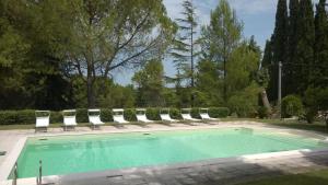 a swimming pool with lounge chairs and a group at Villa degli Scoiattoli in SantʼElpidio a Mare