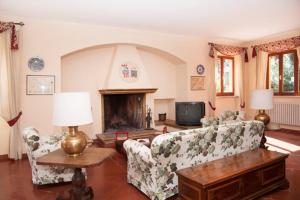 a living room with two couches and a fireplace at Villa degli Scoiattoli in SantʼElpidio a Mare