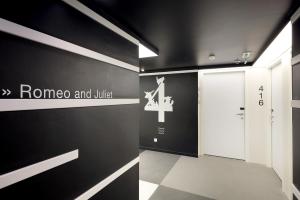 a hallway with a door and a sign on a wall at Eurostars Book Hotel in Munich