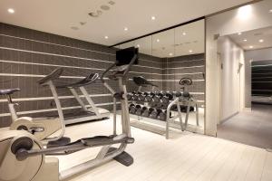 a gym with a treadmill and a fitness room at Eurostars Book Hotel in Munich