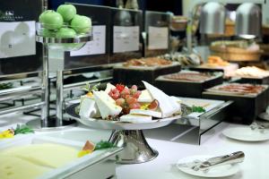 a buffet with a plate of food on a table at Eurostars Book Hotel in Munich