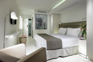 a hotel room with a large white bed in it at Eurostars Book Hotel in Munich