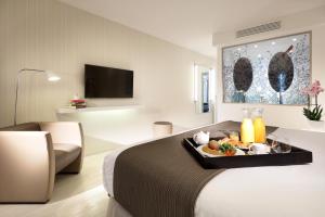 a hotel room with a tray of food on a bed at Eurostars Book Hotel in Munich