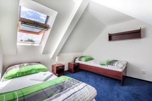 Postel nebo postele na pokoji v ubytování Hotel Pivovar Kácov