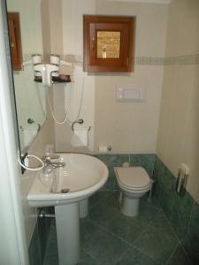 a bathroom with a sink and a toilet at Hotel Fontana Santa in Grumello del Monte